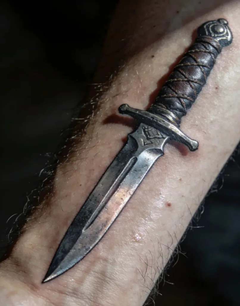 Dagger tattoo meaning with rose or heart: deep symbols of love and pain